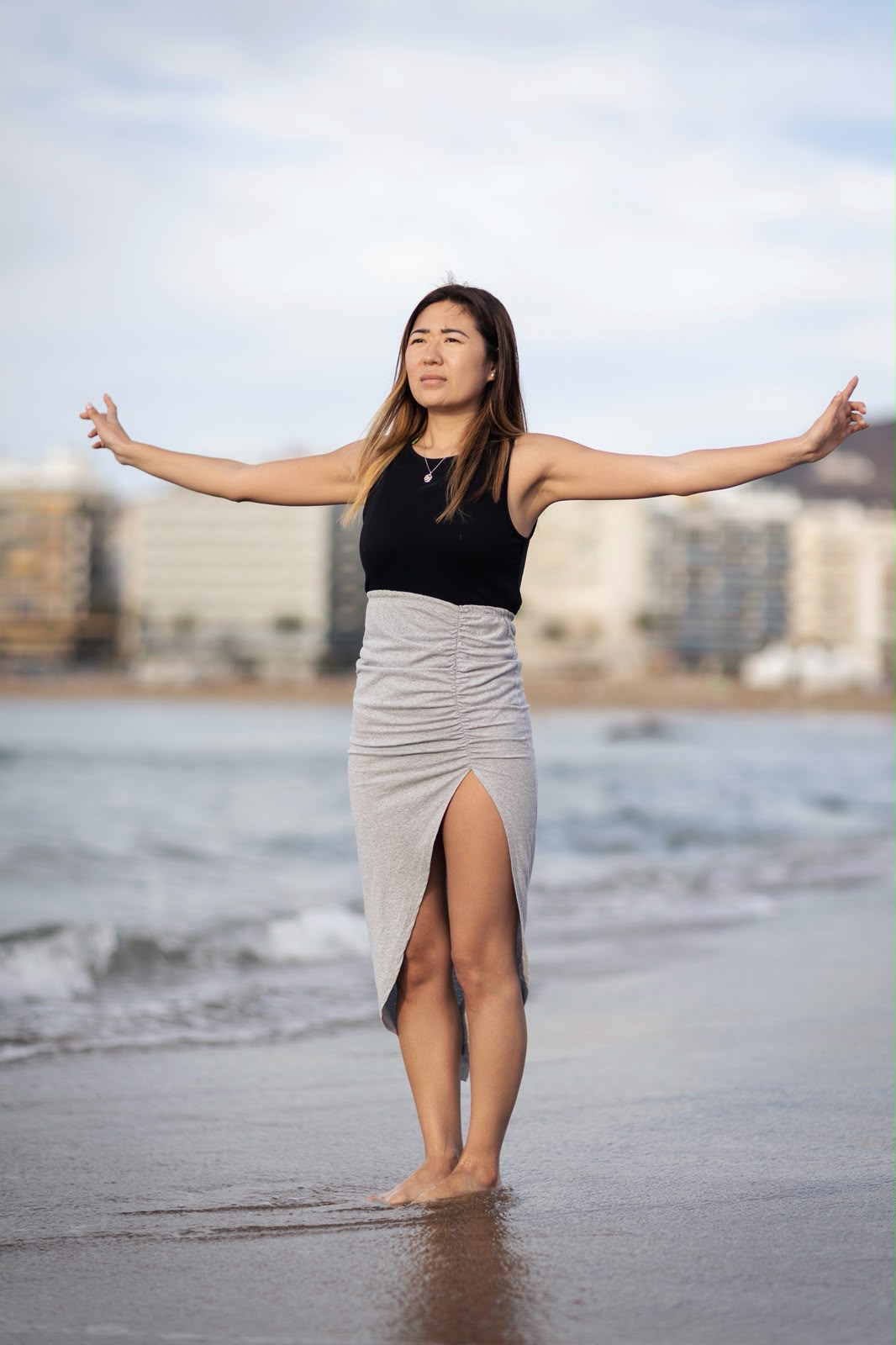 Blanca Zhang con los brazos abiertos frente al mar